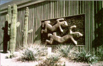 photo of Thomas Road Overpass, Phoenix, Arizona, showing a sculpture, cactus, and wild growth