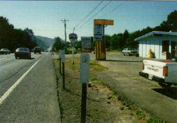 photo of road before improvements; parking lot on right