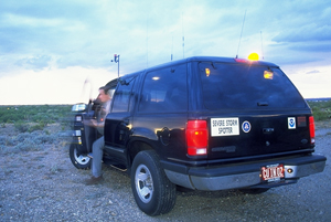 Photo.  Vehicle with the sign “Severe Storm Spotter.” 