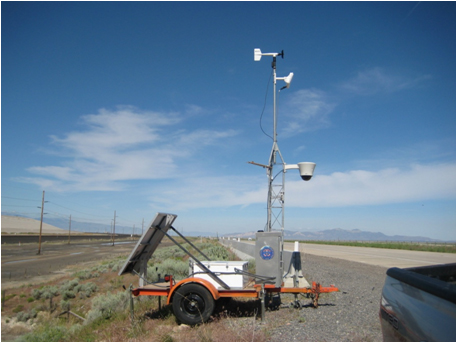 Figure 4.5 - Photo - This figure shows a picture of a mobile Environmental Sensor Station along the side of a freeway. The station is sitting on a trailer and includes a solar panel.