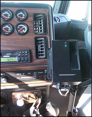 Displays a picture showing the biometric fingerprint reader box in the truck's cab, mounted near the lower right-hand side of the cab's instrument panel