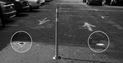 Photo of sensors embedded in entrance and exit lanes of parking lot pavement