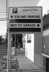 Sign for Seattle Center showing printed directions to parking facilities and windows for the current number of spaces at each facility