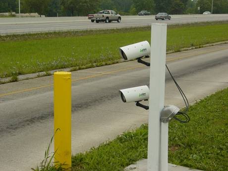Figure 12. Photograph. Close-up view of two automated license plate reader system cameras; mounted to the right of the scale house lane (Laurel County, KY).