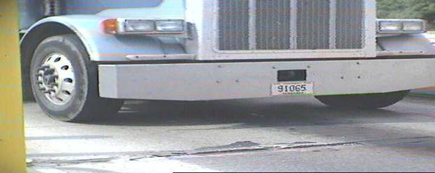 Second photograph showing a wide angle view of semi tractor, with license plate numbers clearly visible.