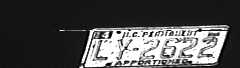 Third photograph showing an arrow angle view of the front license plate only, with letters faint and unable to be read or digitally converted by optical character recognition.