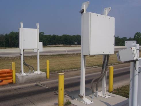 Figure 8. Photograph of raised panels on radiation detector, to left and right of the slow-down lane at Laurel County station. The laser scanner and electronic light beam vehicle detection hardware is also shown as part of the ISSES apparatus.